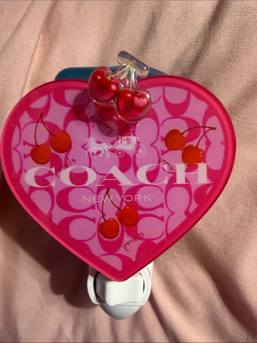 Pink heart with cherry design plug in night light.  Bulb not included.